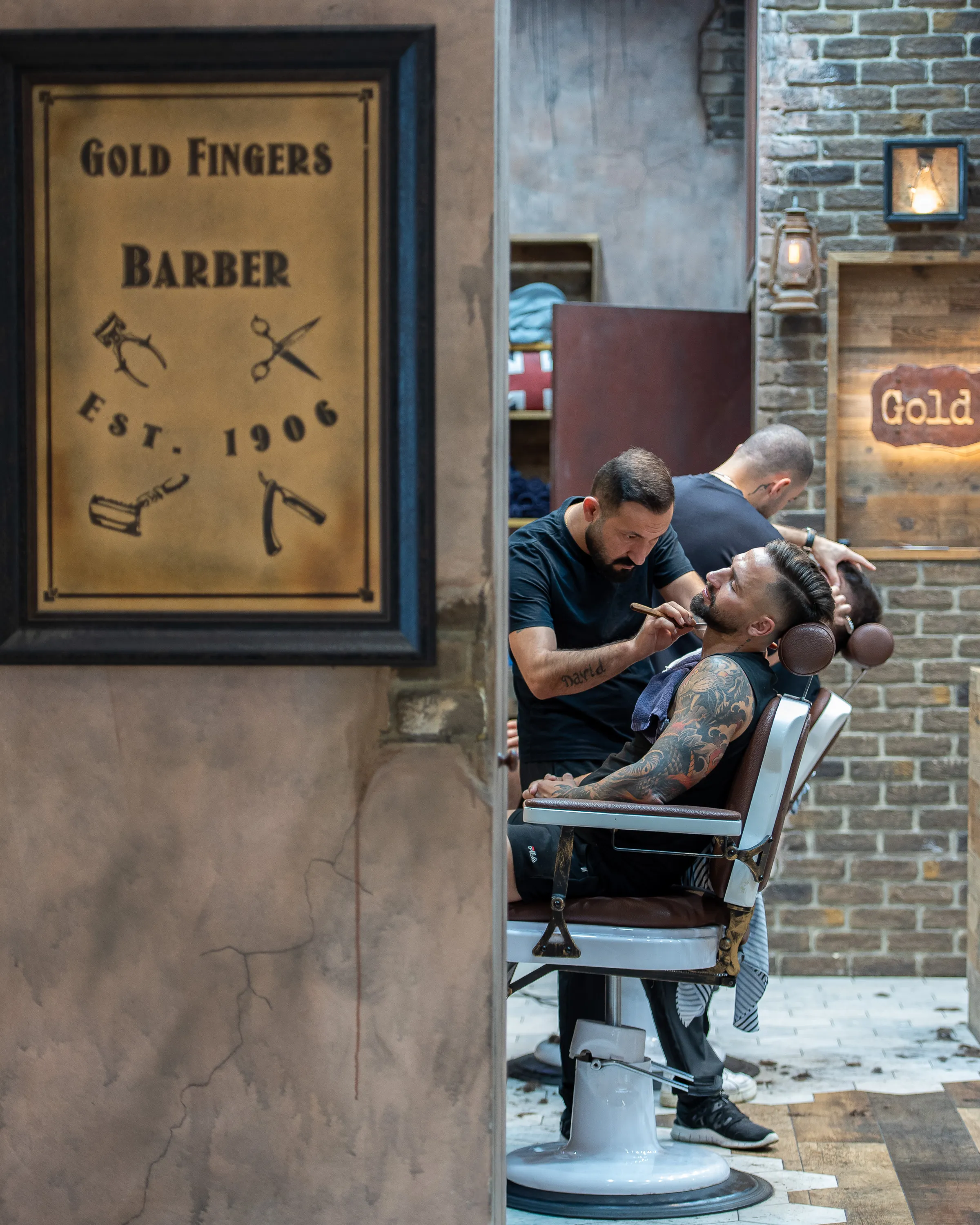 Gold Fingers Barber sign beside the barber chairs